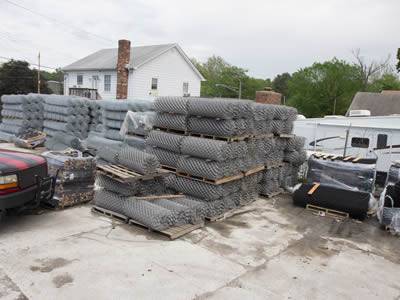 Rolls of chain link wire meshes for silt fencing are stored in the warehouse.